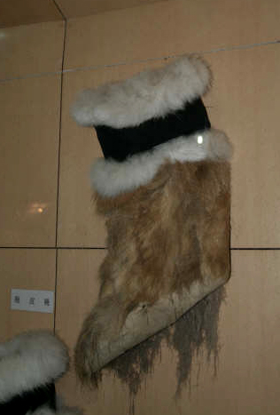 Photo of fur boot, trimmed with black fur, and probably of deer skin